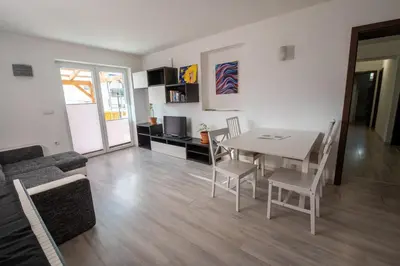 a living room with a table and a couch at Apartma Katja in Škofja Loka