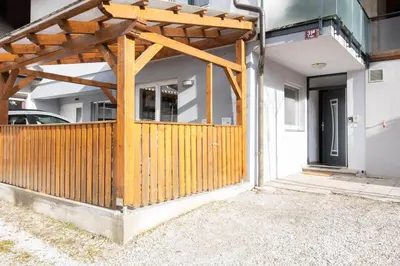 a wooden entrance to a house with a wooden fence at Apartma Katja in Škofja Loka