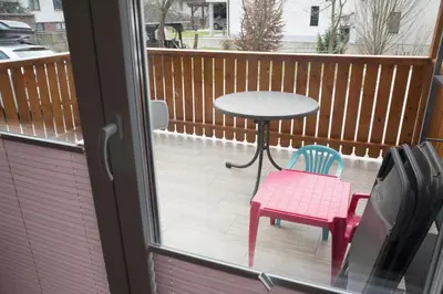 a patio with a table and two chairs on a balcony at Apartma Katja in Škofja Loka
