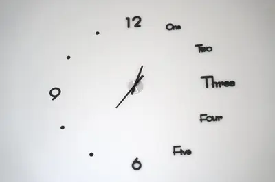 a white clock with different clocks on it at Apartma Pikabooth in Topolšica