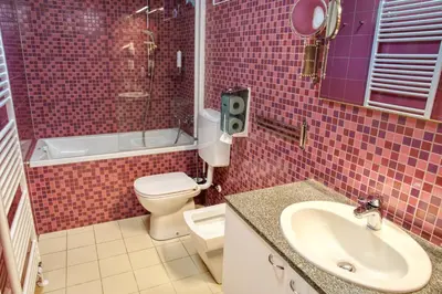 a bathroom with a toilet and a sink and a shower at Apartma Pikabooth in Topolšica