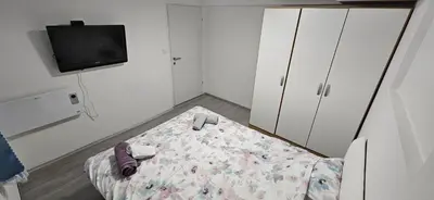 a small room with a bed and a tv at CILT in Kranj