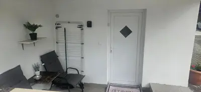 a room with a door and a chair and a table at CILT in Kranj