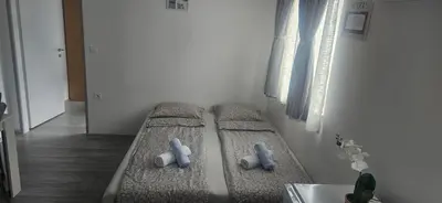 two beds in a room with two teddy bears at CILT in Kranj