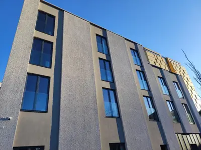 a building with many windows on the side of it at Tivoli Boutique Inn in Ljubljana