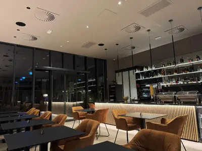a restaurant with tables and chairs and a bar at Tivoli Boutique Inn in Ljubljana