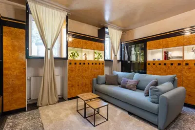 a living room with a blue couch and a table at Apartments Perla in Krško