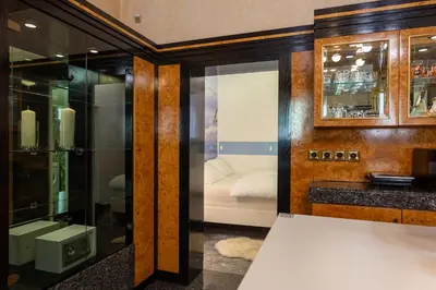 a bathroom with a sink and a bed in a room at Apartments Perla in Krško