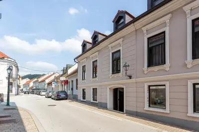 a street in a town with buildings and cars at Apartments Perla in Krško