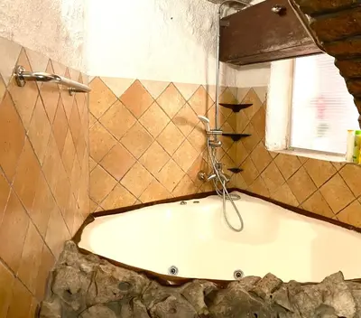 a bath tub in a bathroom with a window at Under The Castle Apartments Ljubljana in Ljubljana