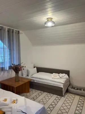 a room with a bed and a couch and a table at Bella Mura Nature Apartment Lipa 97 in Podčetrtek