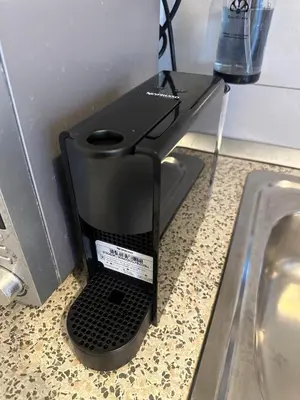 a black router sitting on a counter next to a sink at Bella Mura Nature Apartment Lipa 97 in Podčetrtek