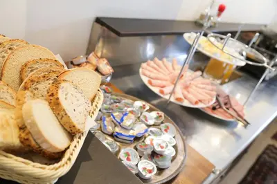 a buffet with bread and other foods on a counter at Budget dbl Studio free breakfast in Ljubljana