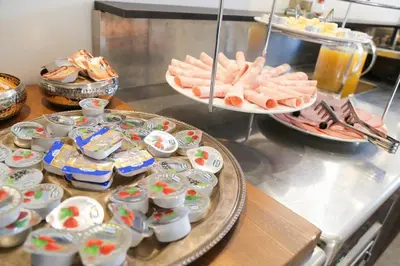 a buffet with plates of food on a table at Budget dbl Studio free breakfast in Ljubljana