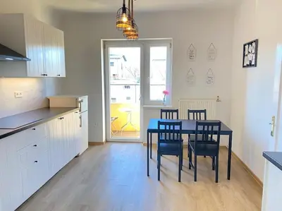 a kitchen and dining room with a table and chairs at Apartment Herberstainova in Ljubljana