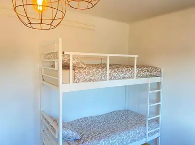 a bedroom with two bunk beds and a chandelier at Apartment Herberstainova in Ljubljana