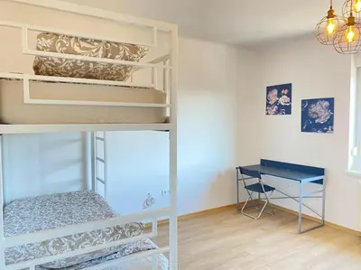 a room with a bunk bed and a desk at Apartment Herberstainova in Ljubljana