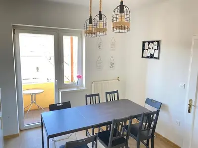 a dining room with a blue table and chairs at Apartment Herberstainova in Ljubljana