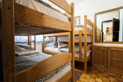 a room with two bunk beds and a mirror at Apartment Maj, Kranjska Gora - Center in Kranjska Gora