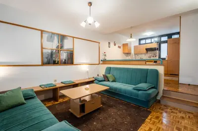 a living room with a blue couch and a table at Apartment Maj, Kranjska Gora - Center in Kranjska Gora