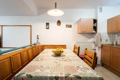 a kitchen with a table with a bowl of fruit on it at Apartment Maj, Kranjska Gora - Center in Kranjska Gora