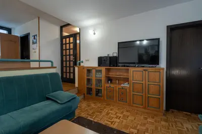 a living room with a couch and a flat screen tv at Apartment Maj, Kranjska Gora - Center in Kranjska Gora