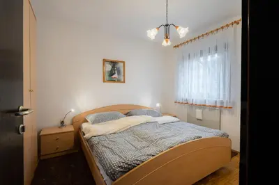 a bedroom with a bed and a window at Apartment Maj, Kranjska Gora - Center in Kranjska Gora