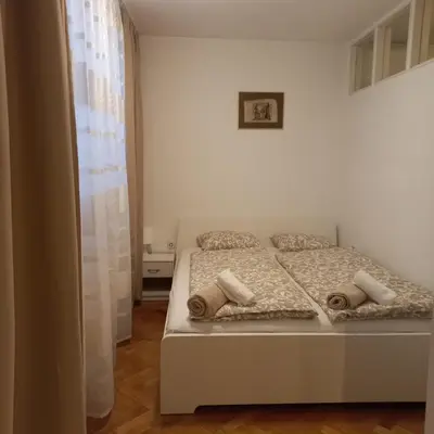 a bedroom with a white bed with two pillows at Apartment Blue Moon in Ljubljana