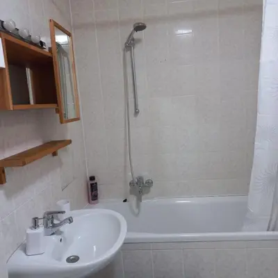 a bathroom with a tub and a sink and a shower at Apartment Blue Moon in Ljubljana