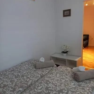 a bedroom with a bed and a table with towels on it at Apartment Blue Moon in Ljubljana