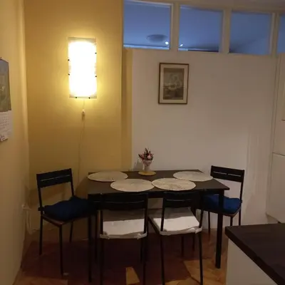 a dining room with a table and four chairs at Apartment Blue Moon in Ljubljana