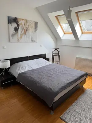 a bedroom with a bed and a ceiling with skylights at Bled lux apartment in Bled