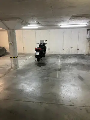 a motorcycle parked in an empty parking garage at Bled lux apartment in Bled