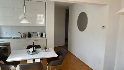 a kitchen and dining room with a table and chairs at Bled lux apartment in Bled