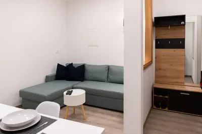 a small living room with a couch and a table at Oliver street apartment Vipava - 50m from city center in Vipava