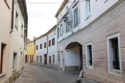 an alley in an old town with white buildings at Oliver street apartment Vipava - 50m from city center in Vipava