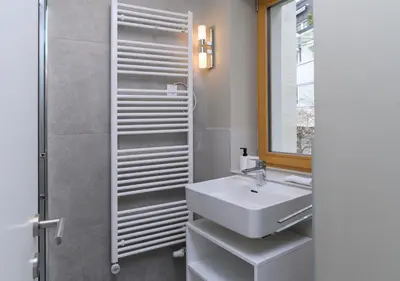 a bathroom with a sink and a shower at Primus apartments in Ljubljana