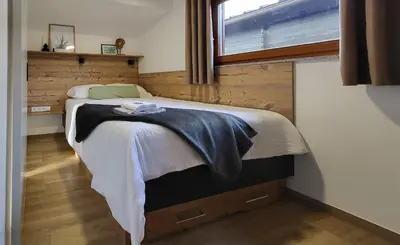 a bedroom with a large bed with a window at HIŠKA TIBAUT 122 vključene kopalne karte in Veržej