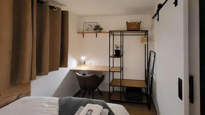 a bedroom with a desk and a chair and a bed at HIŠKA TIBAUT 122 vključene kopalne karte in Veržej