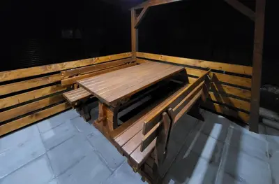 a wooden picnic table sitting on top of a deck at HIŠKA TIBAUT 122 vključene kopalne karte in Veržej