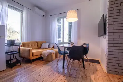a living room with a table and a couch at Garden apartment No.3 in Bled