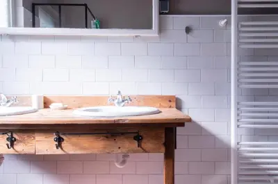 a bathroom with two sinks and a mirror at Garden apartment No.3 in Bled