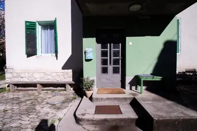 a shadow of a person standing outside of a house at Garden apartment No.3 in Bled