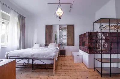 a bedroom with a bed and a shelf with books at Garden apartment No.3 in Bled