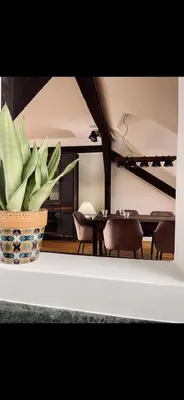 a vase with a plant sitting on a table at JZ Loft Ljubljana with Parking and Self Check in in Ljubljana