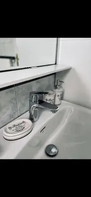 a bathroom sink with a faucet and a mirror at JZ Loft Ljubljana with Parking and Self Check in in Ljubljana
