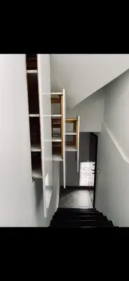 a hallway with shelves and a staircase in a building at JZ Loft Ljubljana with Parking and Self Check in in Ljubljana