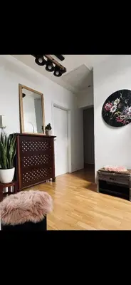 a living room with a couch and a mirror at JZ Loft Ljubljana with Parking and Self Check in in Ljubljana