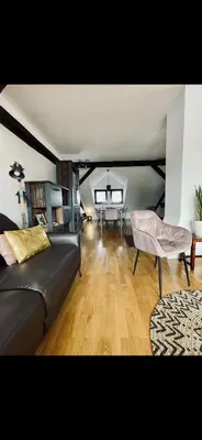 a living room with a couch and a table at JZ Loft Ljubljana with Parking and Self Check in in Ljubljana