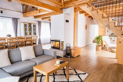 a living room with a couch and a fireplace at Pri stari mami in Tomaž pri Ormožu